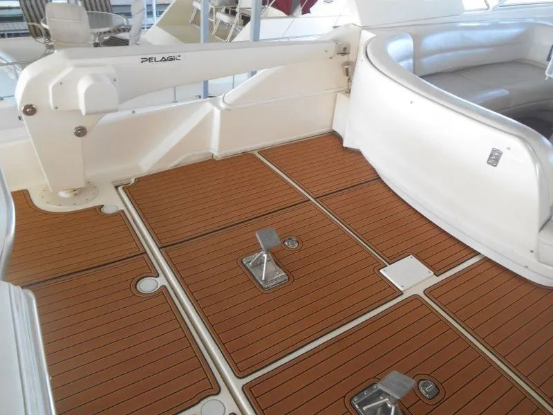 Slide: The Image of 2004 Meridian 540 Pilothouse yacht deck with teak flooring and seating area. - 6