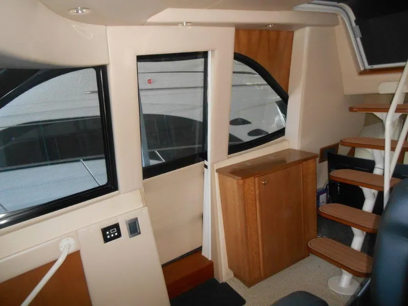 Slide: The Image of Interior of 2004 Meridian 540 Pilothouse with wooden cabinetry and spiral staircase. - 7