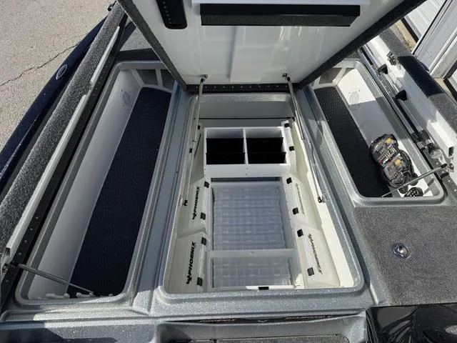 Slide: The Image of Open storage compartments in a 2025 Phoenix 21 XE boat. - 11