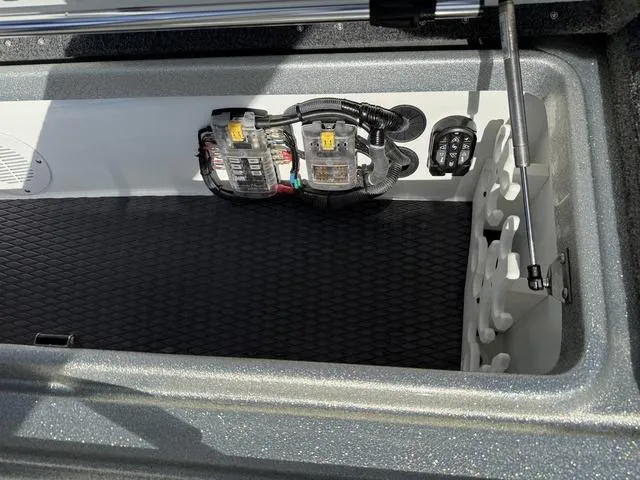 Slide: The Image of 2025 Phoenix 21 XE boat storage compartment with electrical components and organized layout. - 12