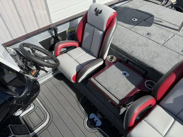 Slide: The Image of 2025 Phoenix 21 XE boat interior with steering wheel and cushioned seats. - 15