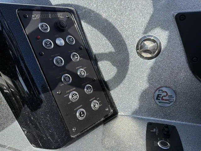 Slide: The Image of Control panel of 2025 Phoenix 21 XE boat with steering wheel and buttons. - 18