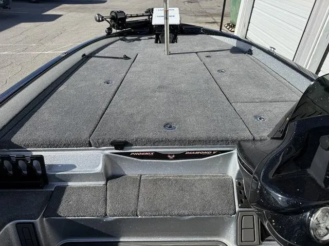 Slide: The Image of 2025 Phoenix 21 XE boat deck with carpeted surface and storage compartments. - 20