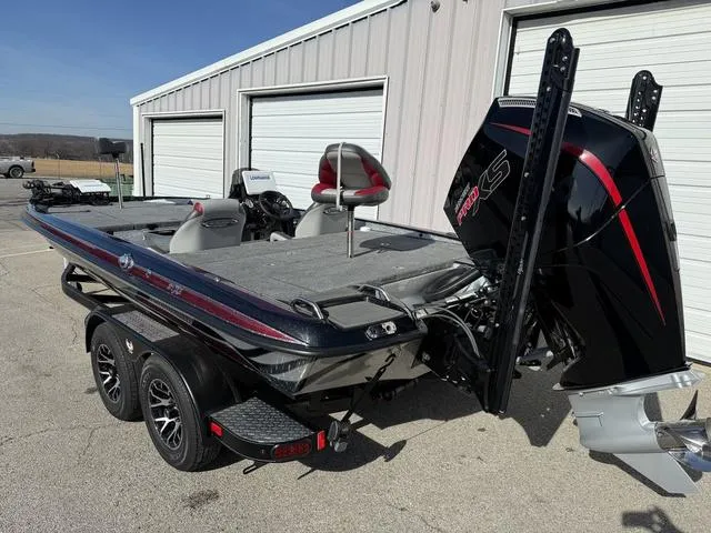 Slide: The Image of 2025 Phoenix 21 XE boat with powerful engine, parked near a garage. - 4