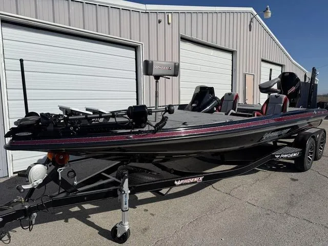 Slide: The Image of 2025 Phoenix 21 XE fishing boat parked outside a garage. - 6