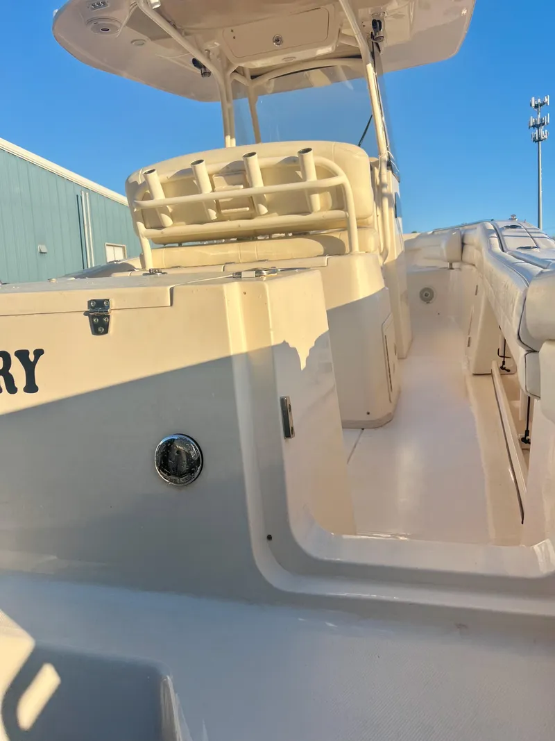 Slide: The Image of 2018 Grady-White Canyon 271 FS boat, white exterior, docked under clear blue sky. - 10