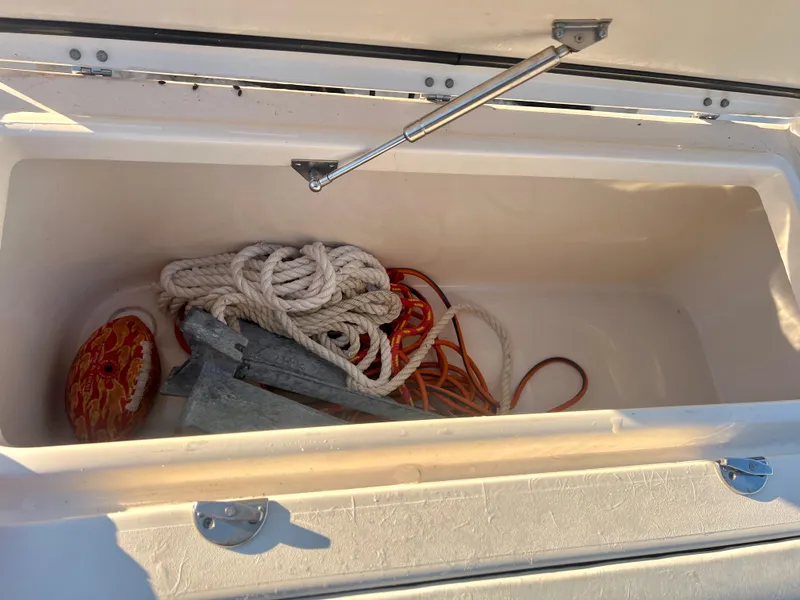 Slide: The Image of Storage compartment with ropes and anchor on 2018 Grady-White Canyon 271 FS boat. - 14