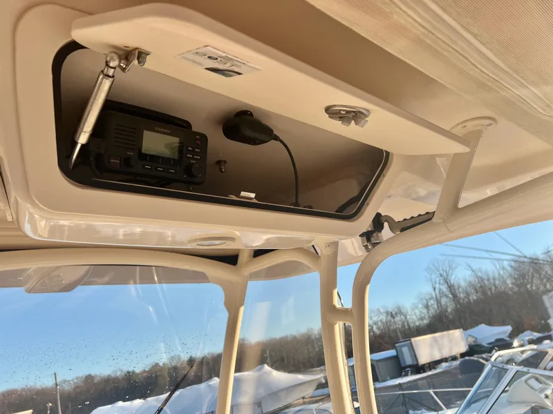 Slide: The Image of 2018 Grady-White Canyon 271 FS boat console with radio and storage compartment. - 17