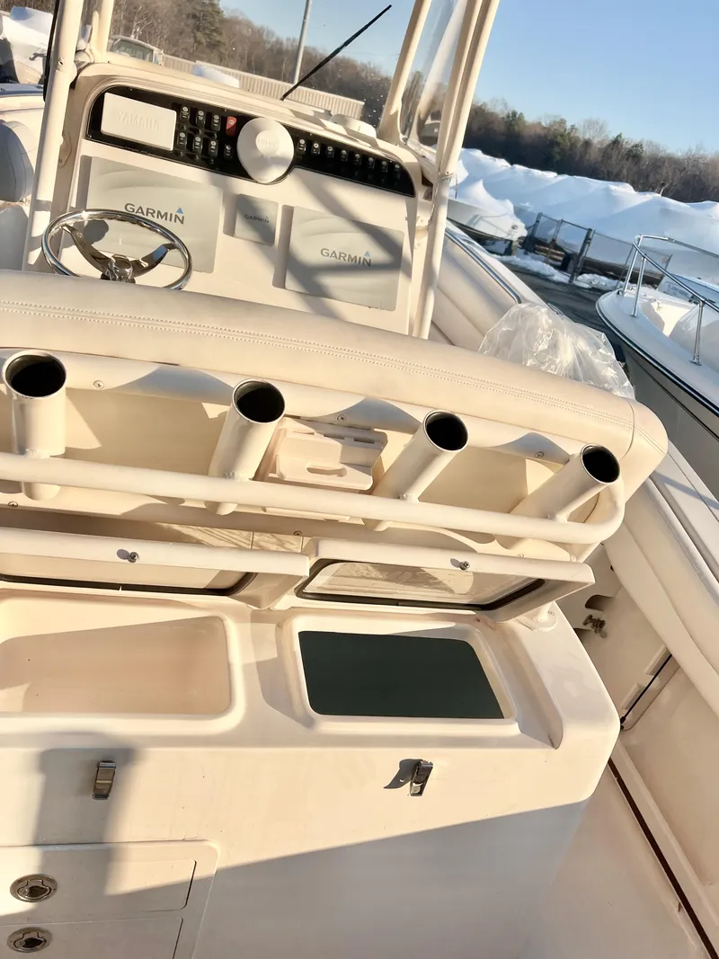 Slide: The Image of 2018 Grady-White Canyon 271 FS boat interior with rod holders and Garmin electronics. - 20