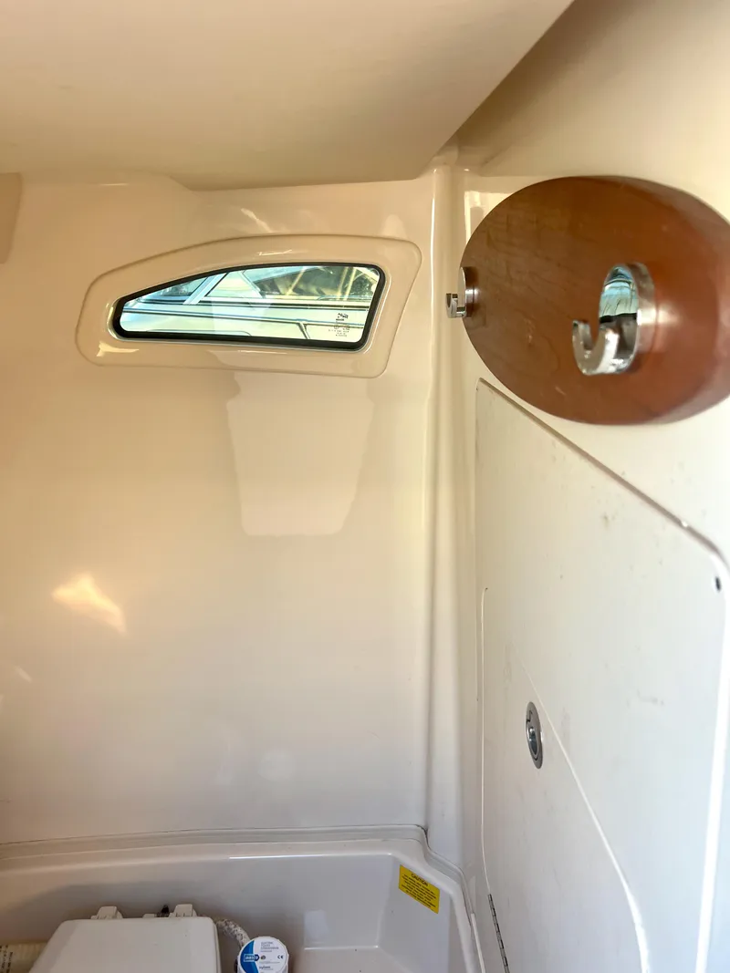 Slide: The Image of Interior of 2018 Grady-White Canyon 271 FS boat cabin with window and hook. - 28