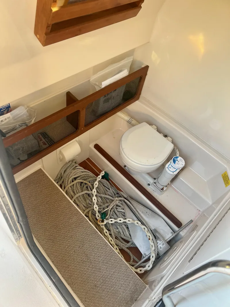 Slide: The Image of 2018 Grady-White Canyon 271 FS boat interior with storage and marine toilet. - 29