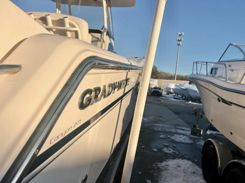 Slide: The Image of 2018 Grady-White Canyon 271 FS boat in a marina, side view. - 3