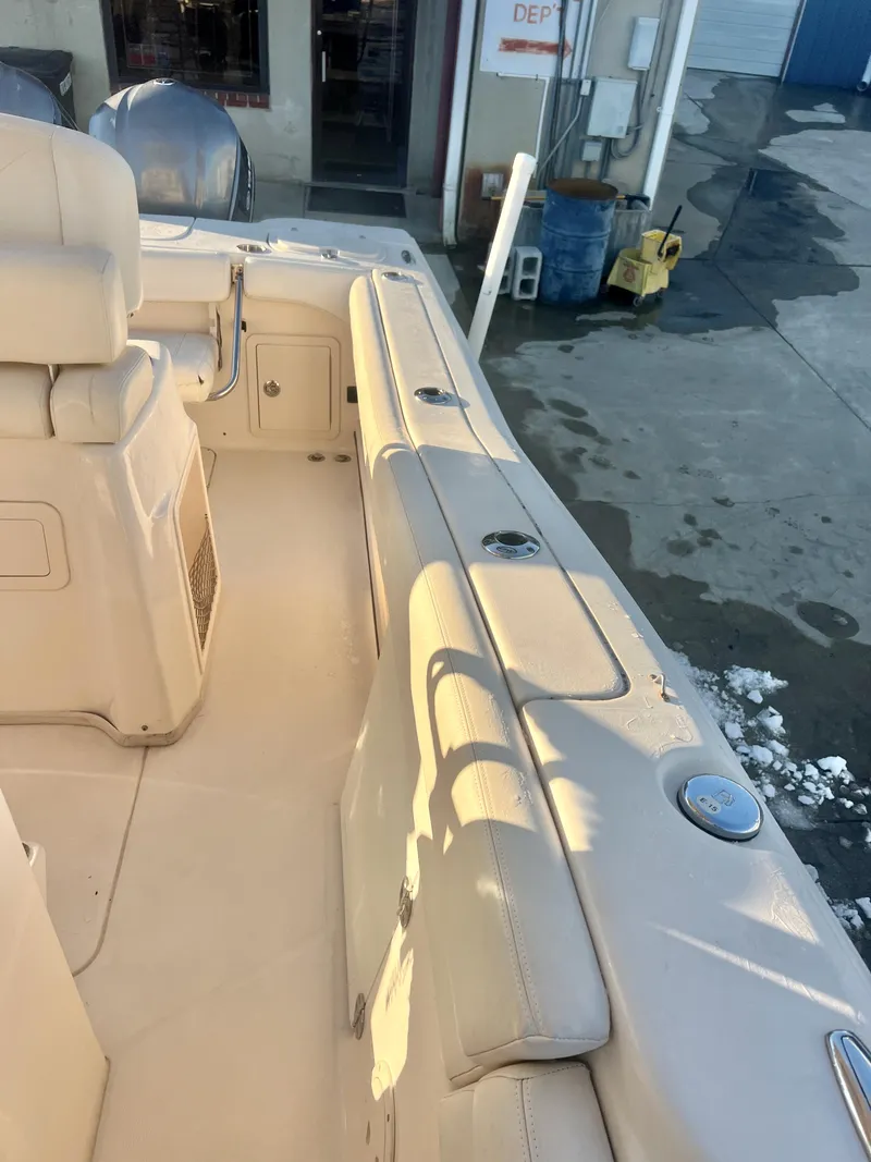 Slide: The Image of 2018 Grady-White Canyon 271 FS boat interior, featuring seating and storage compartments. - 32