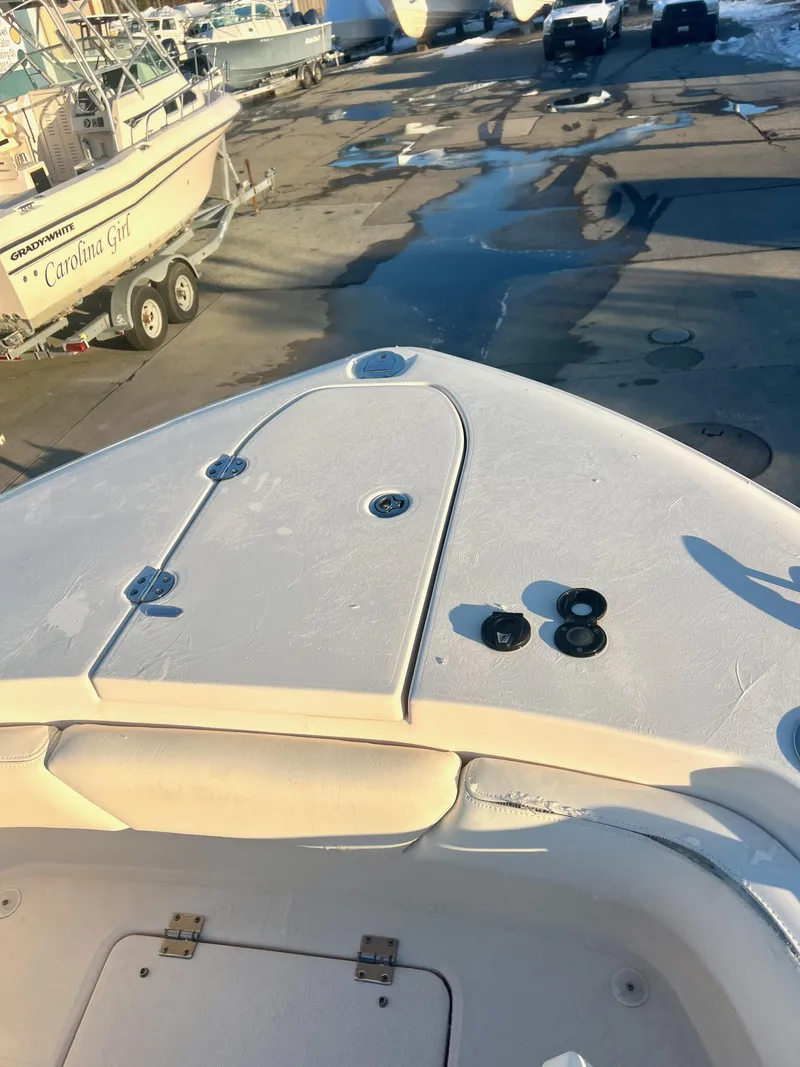 Slide: The Image of 2018 Grady-White Canyon 271 FS boat on a trailer in a marina. - 41