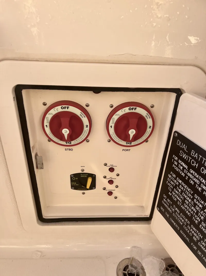 Slide: The Image of 2018 Grady-White Canyon 271 FS dual battery switch panel with red dials. - 43