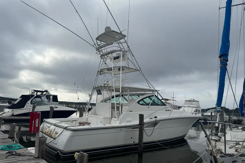 The Image of 2004 Tiara Yachts 4200 Open docked under cloudy skies. - 0