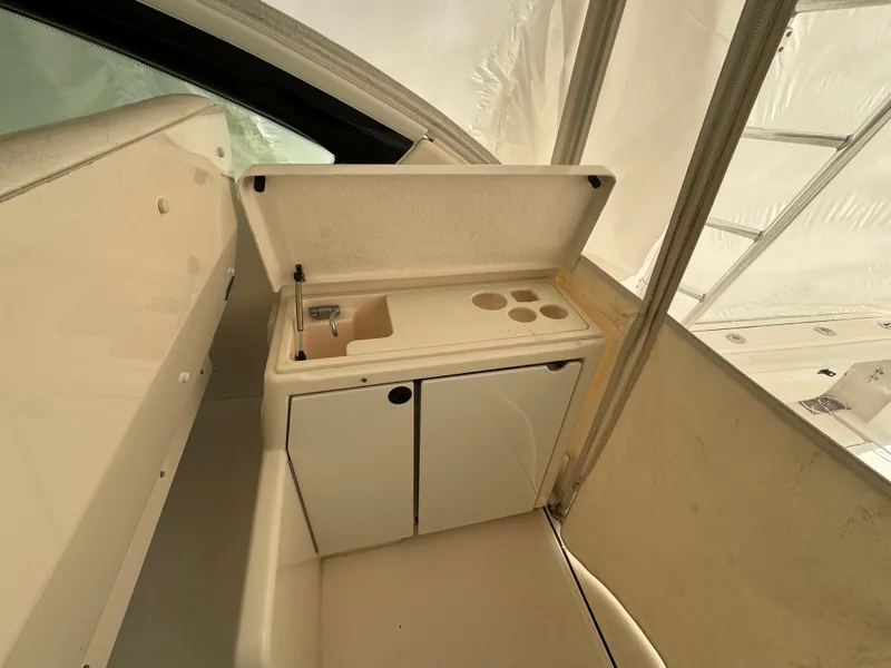 Slide: The Image of 2004 Tiara Yachts 4200 Open interior with storage and sink area. - 14
