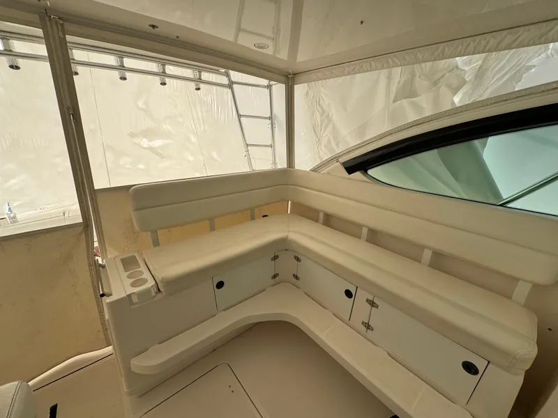 Slide: The Image of 2004 Tiara Yachts 4200 Open interior with white seating and storage compartments. - 15