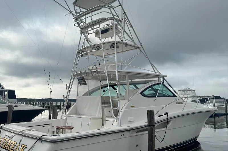 Slide: The Image of 2004 Tiara Yachts 4200 Open docked under cloudy skies. - 2