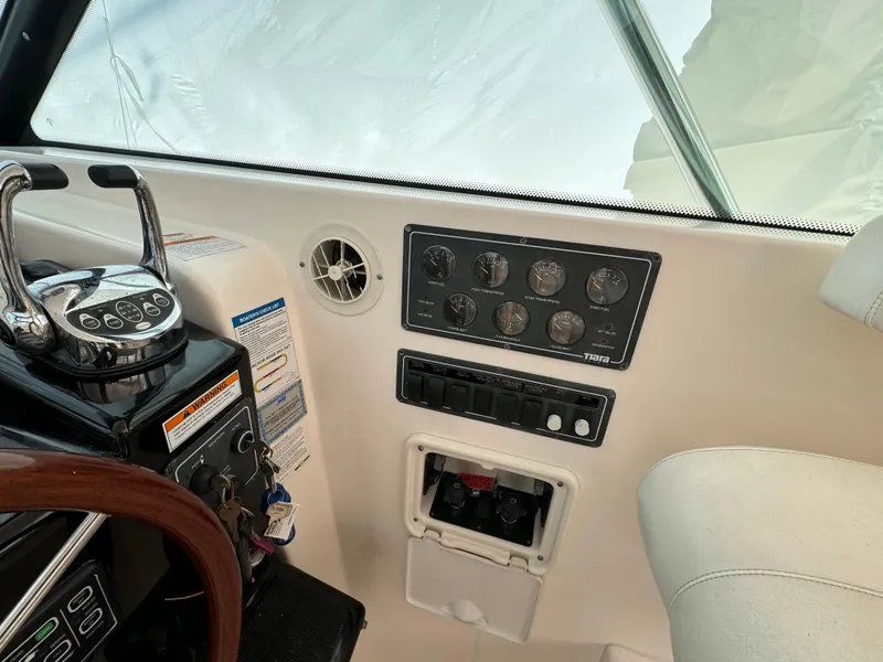 Slide: The Image of Control panel of a 2004 Tiara Yachts 4200 Open, featuring gauges and switches. - 27