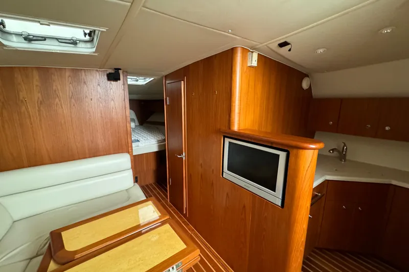 Slide: The Image of Interior of 2004 Tiara Yachts 4200 Open with wood paneling and cozy seating area. - 31