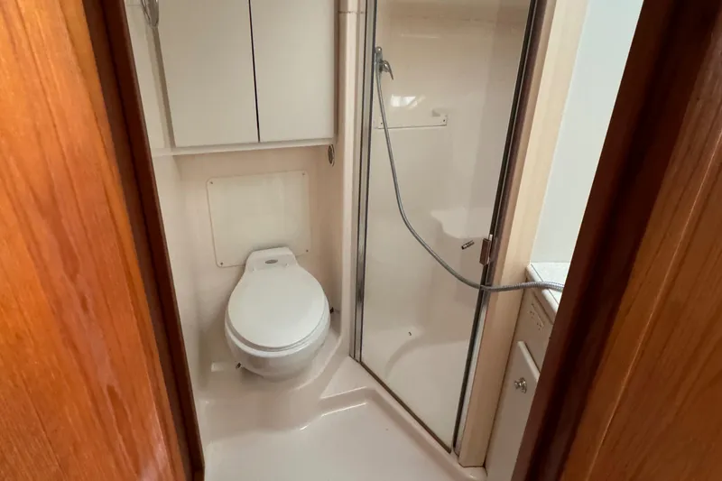 Slide: The Image of Bathroom in 2004 Tiara Yachts 4200 Open, featuring shower and toilet. - 34