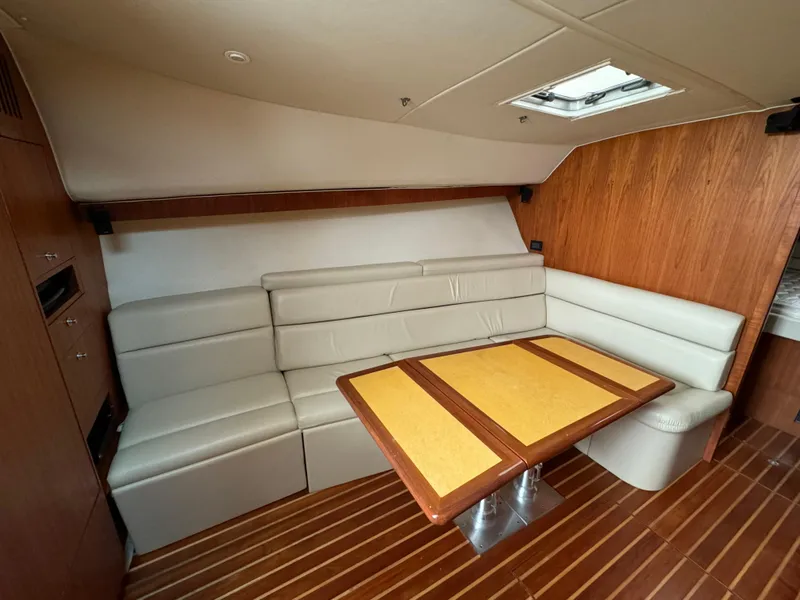 Slide: The Image of Luxurious interior of 2004 Tiara Yachts 4200 Open with elegant seating and wooden table. - 35