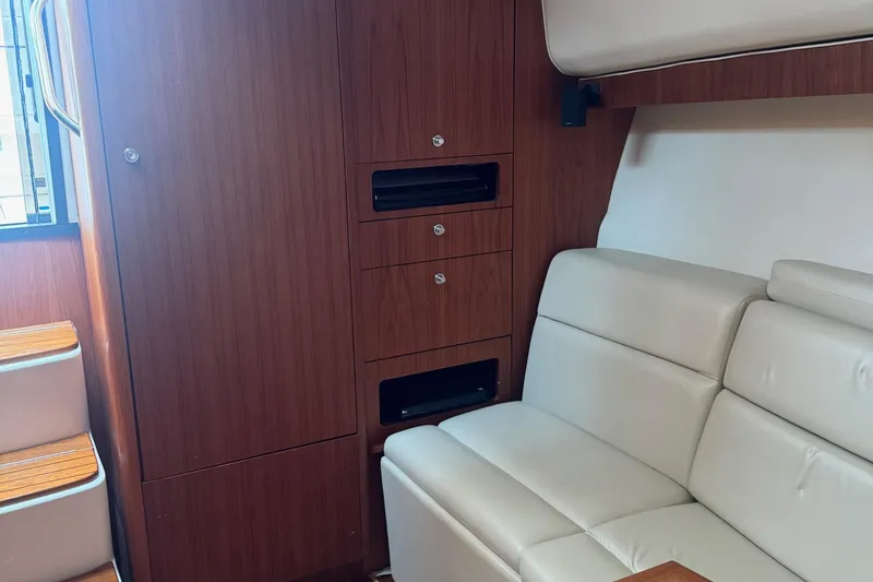 Slide: The Image of 2004 Tiara Yachts 4200 Open interior with beige seating and wooden cabinetry. - 46