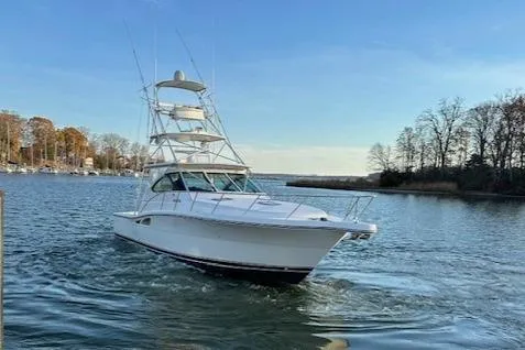 Slide: The Image of 2004 Tiara Yachts 4200 Open cruising on a serene lake with clear skies. - 6