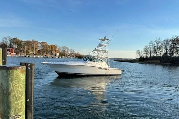 Slide: The Image of 2004 Tiara Yachts 4200 Open cruising on a serene lake. - 8