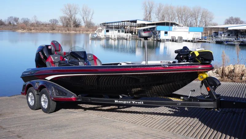 Slide: The Image of 2025 Ranger Z520 boat on trailer by a serene lake dock. - 0