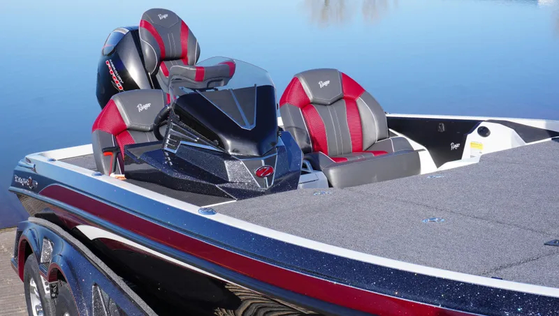 Slide: The Image of 2025 Ranger Z520 boat with sleek design and red-gray seating on a calm lake. - 1