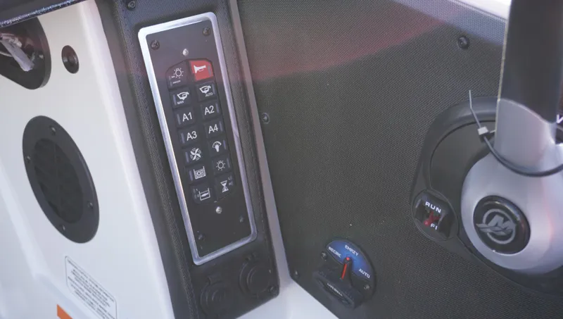 Slide: The Image of Control panel of 2025 Ranger Z520 boat with various switches and dials. - 8