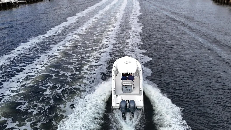 Slide: The Image of Aerial view of 2017 Tidewater 252 LXF boat cruising on open water. - 14