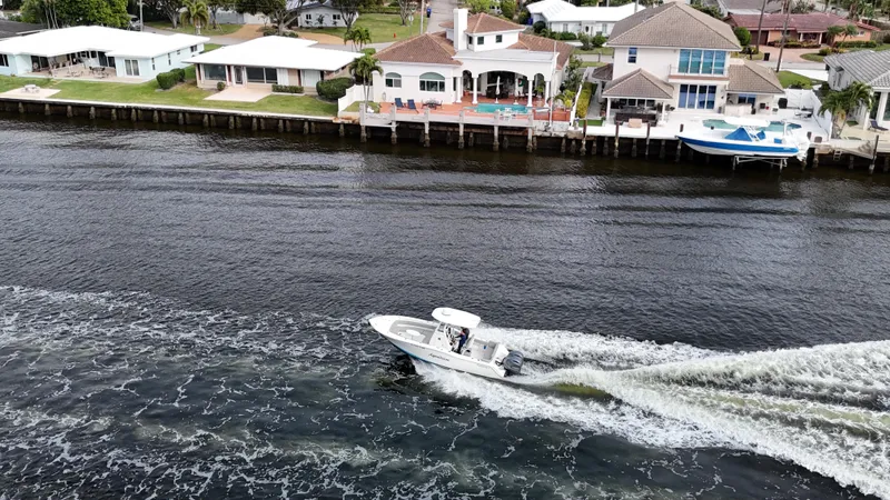 Slide: The Image of Aerial view of 2017 Tidewater 252 LXF boat cruising near waterfront homes. - 15