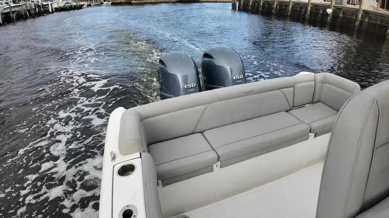 Slide: The Image of 2017 Tidewater 252 LXF boat with dual engines on water. - 19