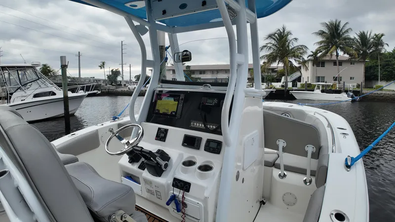 Slide: The Image of 2017 Tidewater 252 LXF boat interior with steering console and navigation equipment. - 21