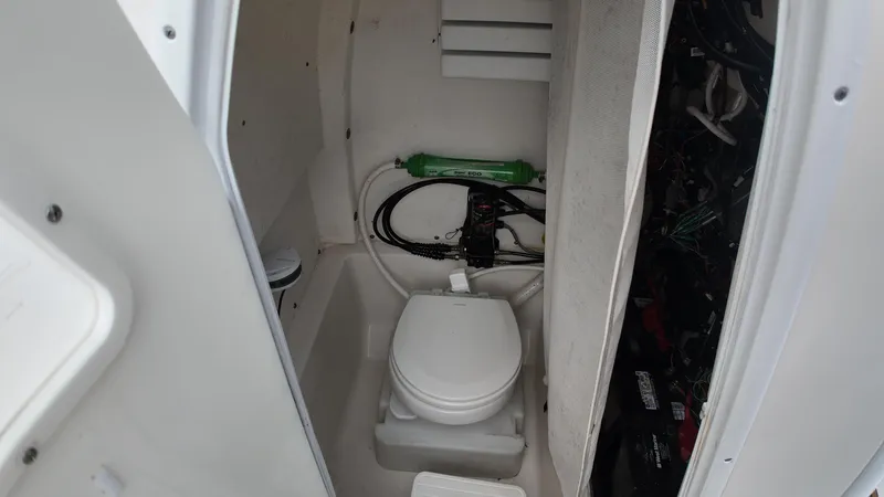 Slide: The Image of 2017 Tidewater 252 LXF boat interior with compact marine toilet. - 27
