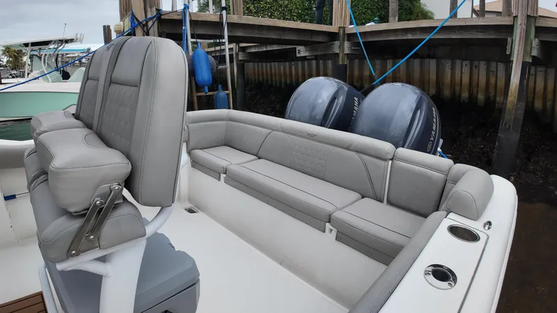 Slide: The Image of 2017 Tidewater 252 LXF boat with dual engines and cushioned seating. - 32
