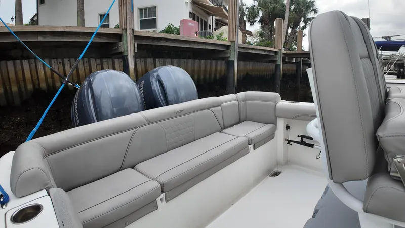 Slide: The Image of 2017 Tidewater 252 LXF boat interior with gray seating and dual outboard motors. - 34
