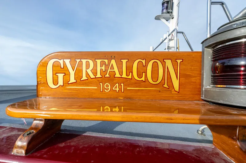 Slide: The Image of Wooden nameplate on 1941 Custom Sagstad Fantail boat, "GYRFALCON," with polished finish. - 1