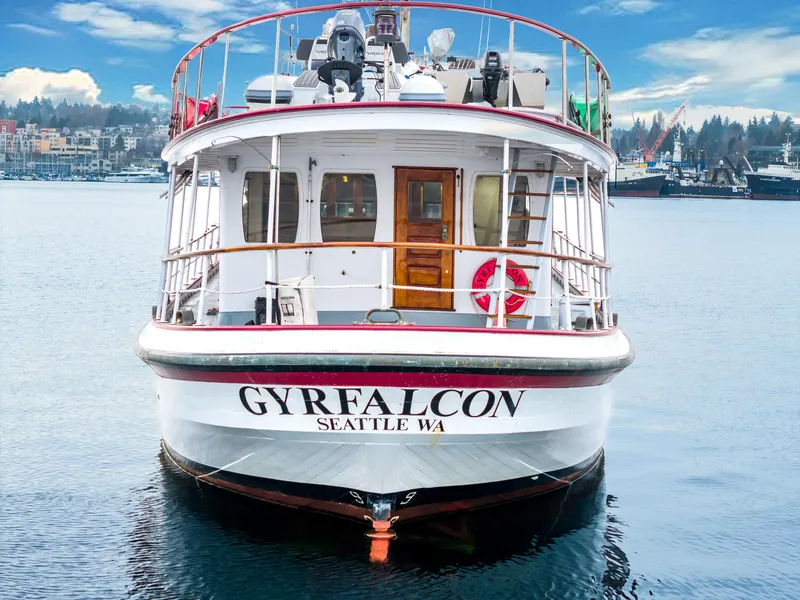 Slide: The Image of Custom 1941 Sagstad Fantail boat "GYRFALCON" docked in Seattle, WA, with scenic waterfront backdrop. - 15