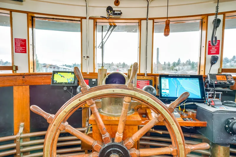 Slide: The Image of 1941 Custom Sagstad Fantail ship's wheelhouse with vintage wooden steering wheel and modern navigation equipment. - 19