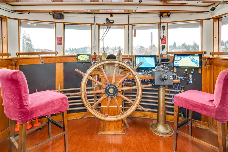 Slide: The Image of Vintage 1941 Custom Sagstad Fantail ship's wheelhouse with wooden helm and modern navigation equipment. - 2