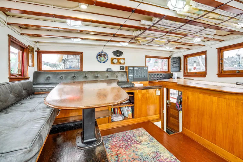 Slide: The Image of Interior of 1941 Custom Sagstad Fantail boat with wooden furnishings and seating area. - 20