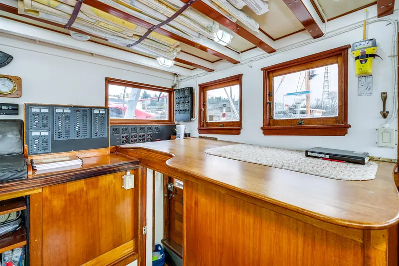 Slide: The Image of 1941 Custom Sagstad Fantail boat interior with wooden cabinetry and control panels. - 21