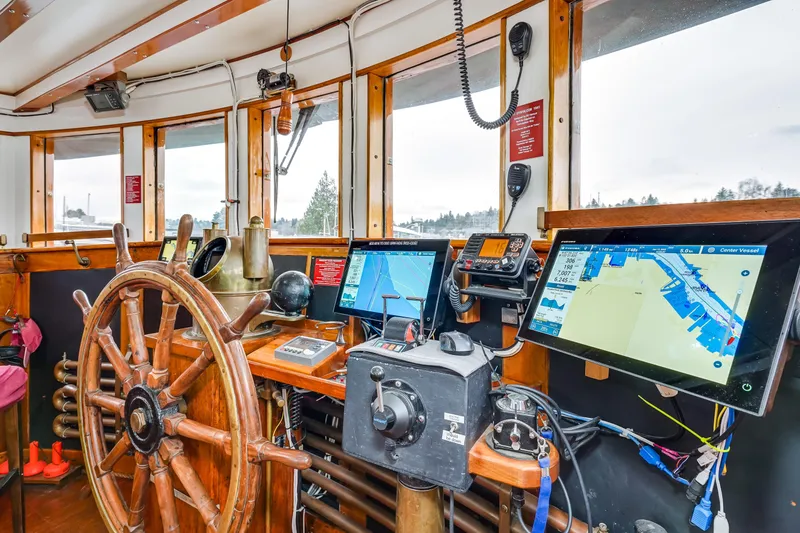 Slide: The Image of 1941 Custom Sagstad Fantail boat helm with wooden wheel and modern navigation equipment. - 25