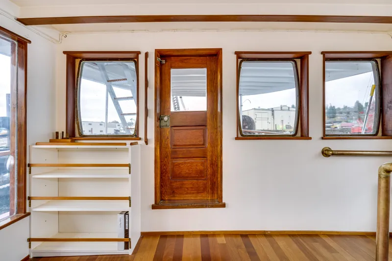 Slide: The Image of Interior of 1941 Custom Sagstad Fantail boat with wooden door, windows, and shelves. - 30