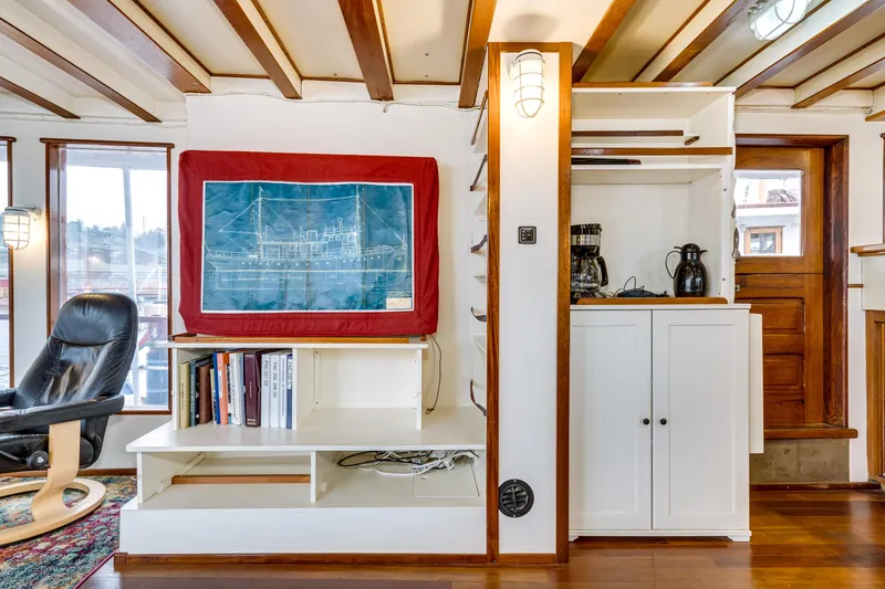 Slide: The Image of Interior of 1941 Custom Sagstad Fantail with bookshelf, blueprint, and wooden beams. - 32