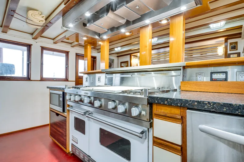Slide: The Image of 1941 Custom Sagstad Fantail kitchen with modern appliances and wooden accents. - 38